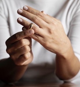 Person removing wedding ring.
