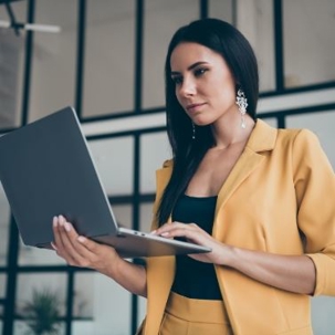Woman holding a laptop.