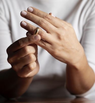 person taking off wedding ring